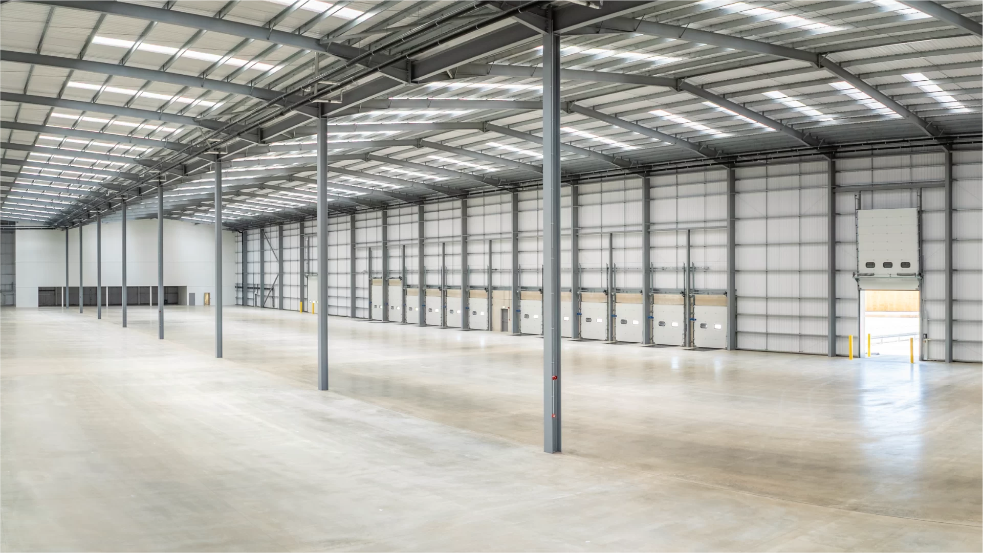 Empty modern warehouse interior with loading bays